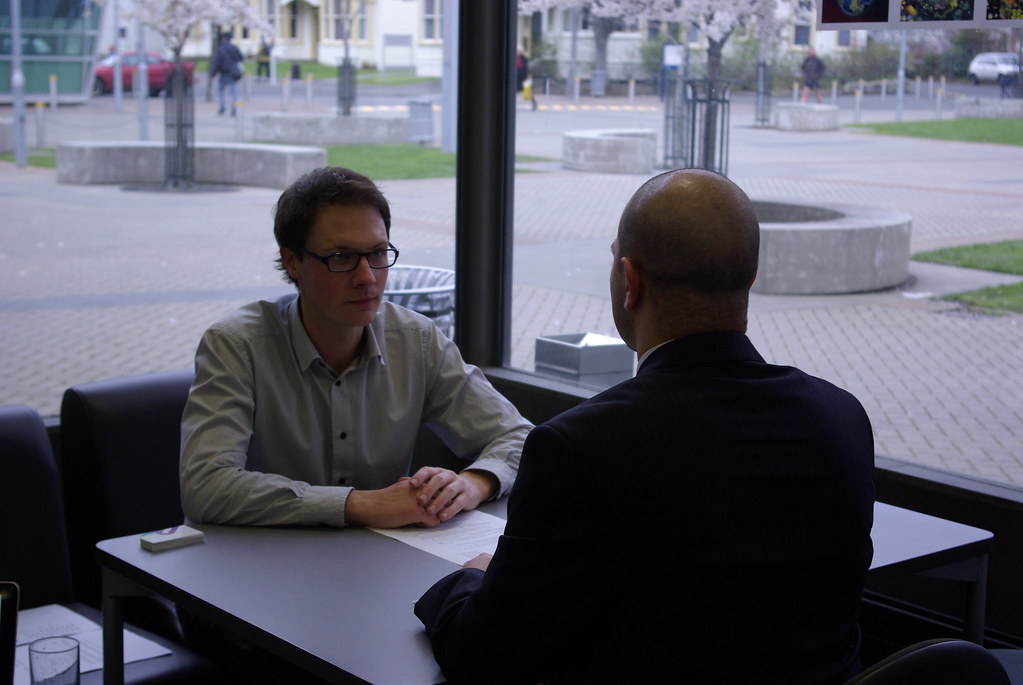 A job candidate in an interview across the desk from a recruiter